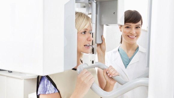 Dental professional taking x-ray of patient