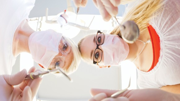 Hygienist or therapist overlooking patient