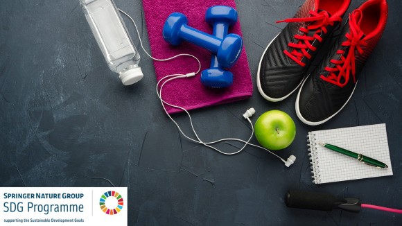 Image of trainers, dumbbells, bottle of water, apple and skipping rope on black concrete background, reflecting the concept of fitness.