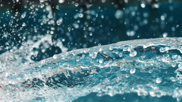 Close up of water splashing with droplets flying in the air