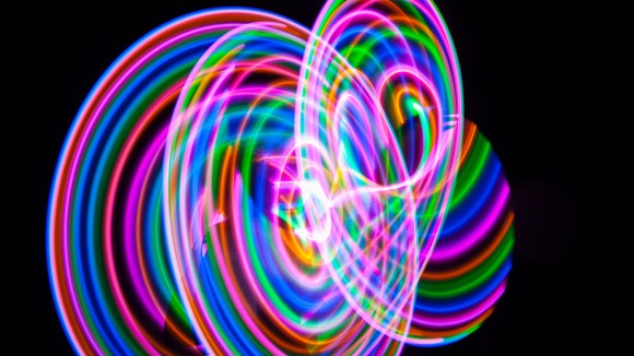 Abstract colorful LED light hula hoop at night - stock photo