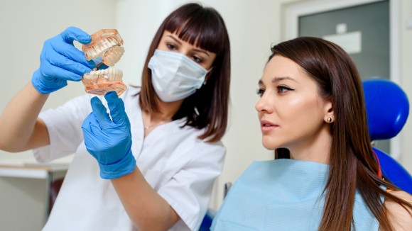 Dentist in conversation with patient