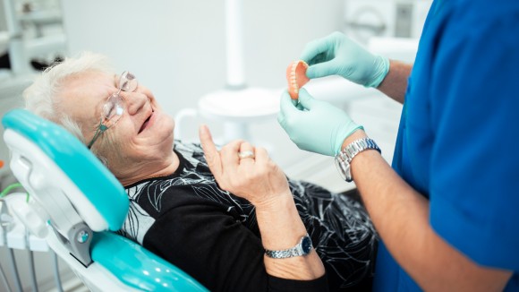 Dentist and elderly patient