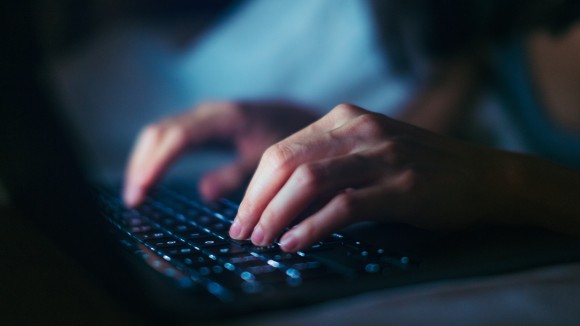 hands typing on a keyboard