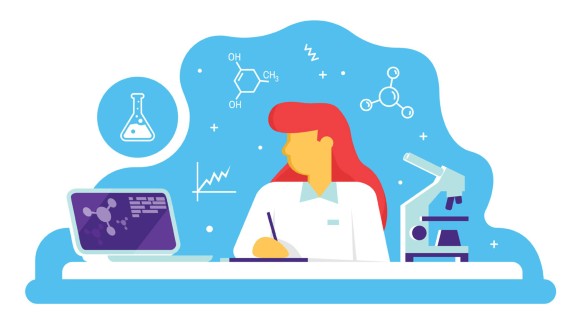 A female researcher working in a lab with a microscope and a laptop.