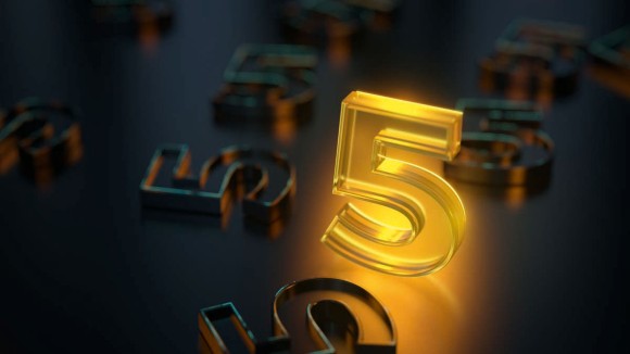 Glowing number five, in yellow transparent glass material, standing out on dark background.