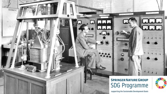 Black and white photograph of two men near a mass spectrometer
