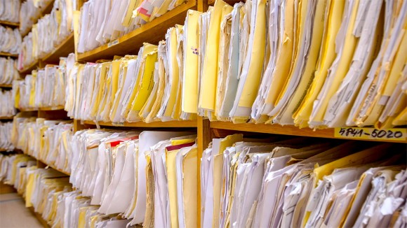 Policy documents in organised folders on a shelf