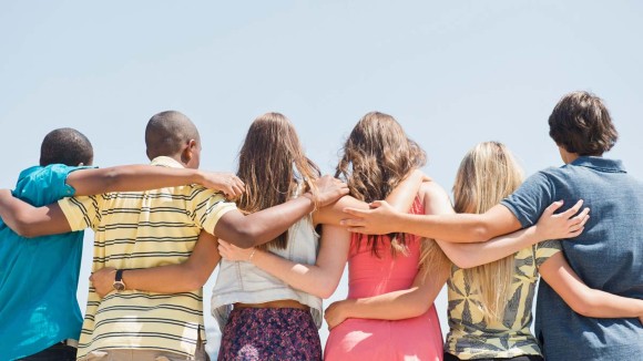 Group of adolescents hugging each other