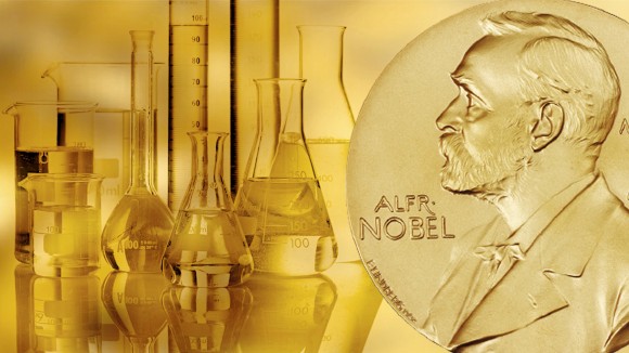 A Nobel Prize medal sitting in front of a gold background featuring typical glassware from a chemistry laboratory.