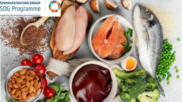 Foods high in iron on a light grey background; there is a fish, grains,peas, broccoli, an egg, salmon, mushrooms, chicken, almonds, tomato, basil, liver, lentils.