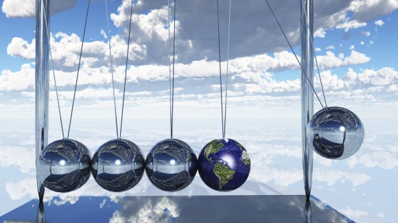 Globe amongst Newton's cradle within clouds.