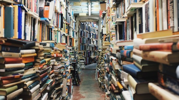 Bookstore with used books stacked from floor to ceiling.