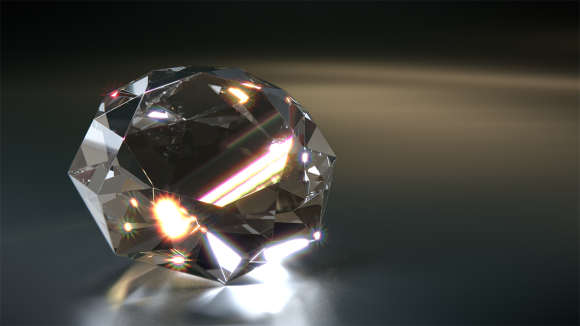 A round brilliant-cut diamond reflecting light on a black background