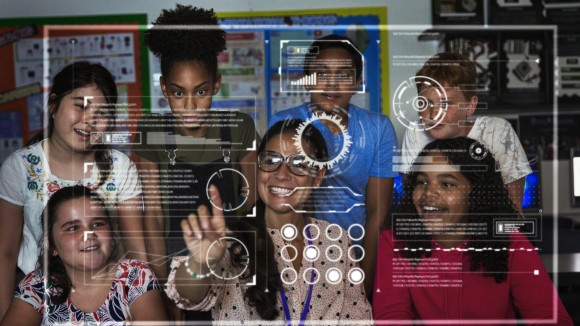 Teacher and junior high school students using futuristic touch screen in classroom.