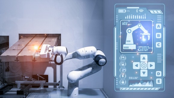 Automated robotic arm working with box in modern distribution warehouse. Technology and futuristic concept