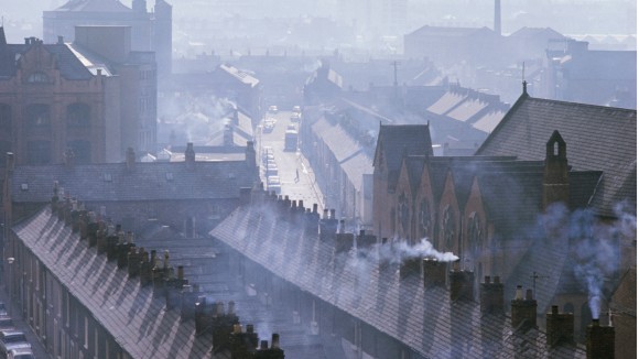 Roofs and smoking chimneys of houses in Belfast.