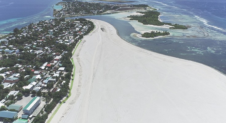 a coastline showing a large stretch of sandy beach seen from above