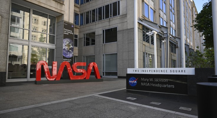 A photograph of the NASA headquarters, with a large read sign that reads "NASA"