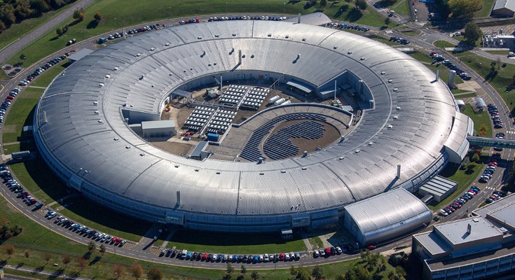 An aerial view of the donut shaped Diamond Light Source building in Oxfordshire