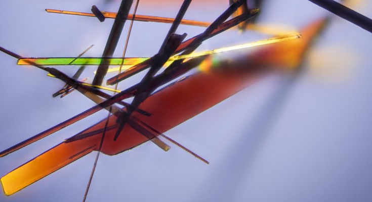 An optical image of a collection of organic crystals, demonstrating their optical transparency.