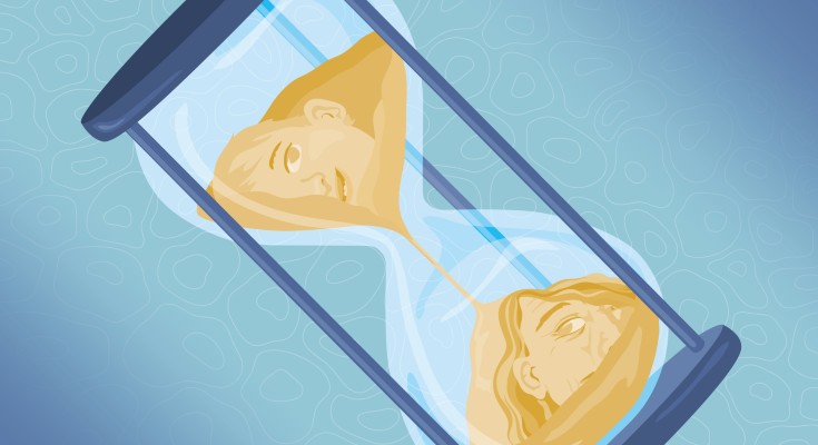 A sand timer with an old face on one side and a young face on the other
