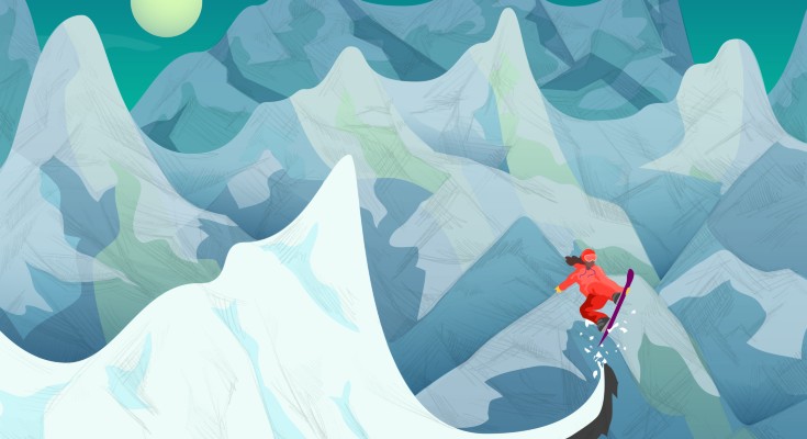 A snowboarder going over a mountainous region